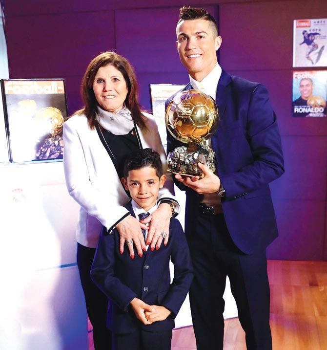Cristiano Ronaldo with his mother Maria Dolores dos Santos Aveiro and son Cristiano Ronaldo Jr in Madrid. Pic/AFP
