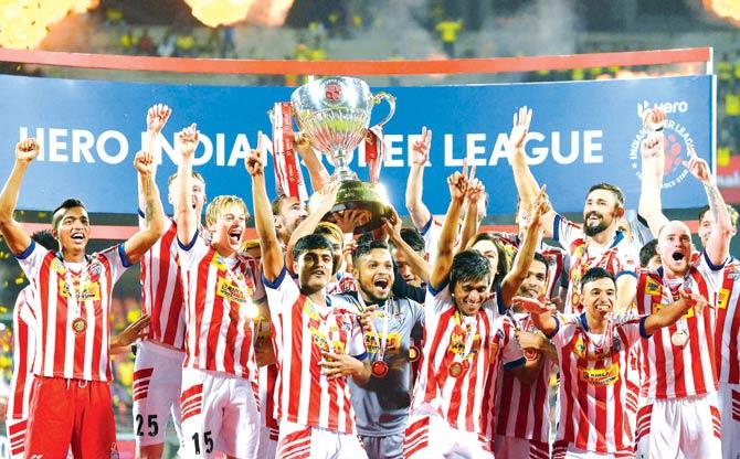 Jubilant Atletico de Kolkata players with the trophy after winning the Indian Super League-3 final against Kerala Blasters at the Jawaharlal Nehru Stadium in Kochi yesterday. ATK won 4-3 on penalties. Pic/Sportzpics
