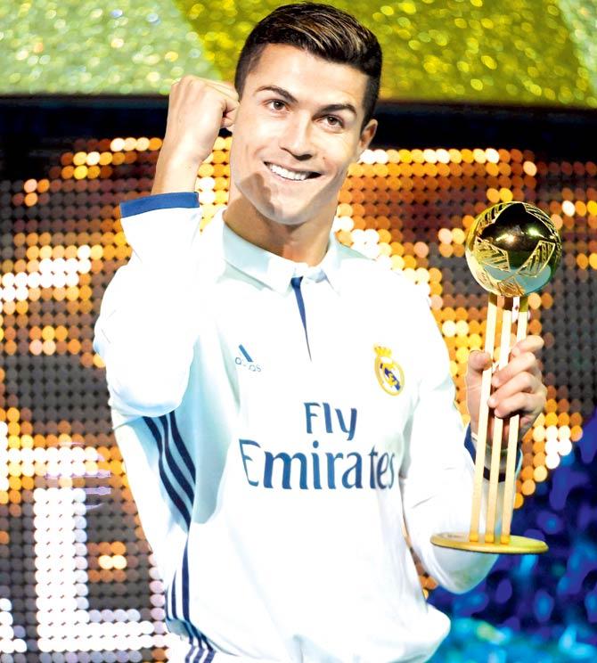 Real Madrid forward Cristiano Ronaldo poses with the Golden Ball trophy yesterday. Pic/AFP