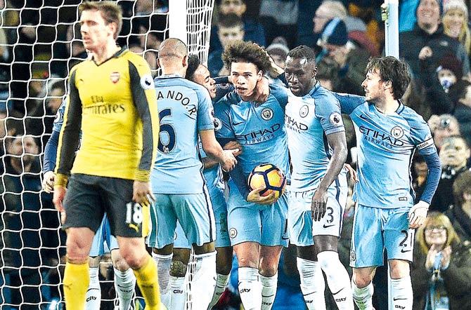 Man City players celebrate a goal against Arsenal during an EPL encounter at the Etihad Stadium in Manchester yesterday. Pic/AFP