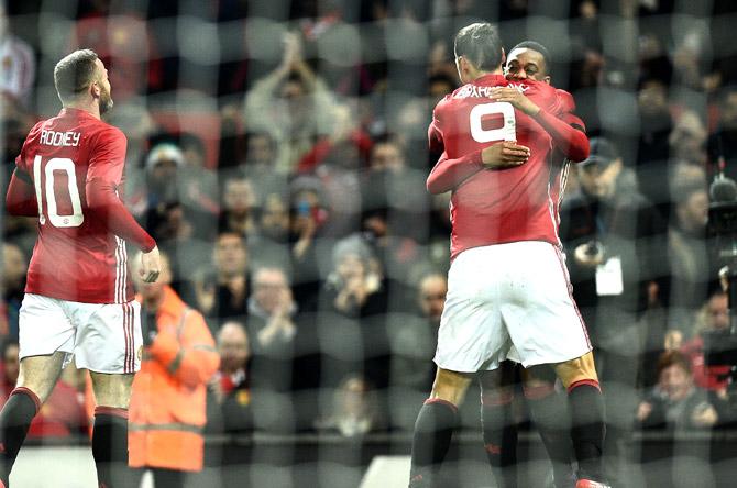 Manchester United-s French striker Anthony Martial R celebrates scoring his team-s second goal with Manchester United-s Swedish striker Zlatan Ibrahimovic C and Manchester United-s English striker Wayne Rooney during the EFL English Football League Cup quarter-final football match between Manchester United and West Ham United at Old Trafford in Manchester. Pic/AFP