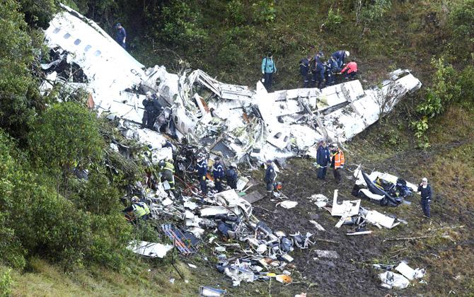 Rescue workers stand at the wreckage site of a chartered airplane that crashed outside Medellin, Colombia, Tuesday, Nov. 29, 2016. The plane was carrying the Brazilian first division soccer club Chapecoense team that was on it-s way for a Copa Sudamericana final match against Colombia-s Atletico Nacional. Pic/AP, PTI