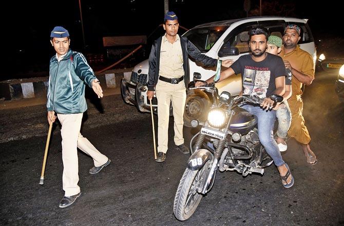 Police personnel pull over bikers near the Vakola bridge on Western Express Highway on Monday night