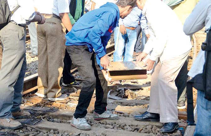 Railway employees clear the track after the derailment