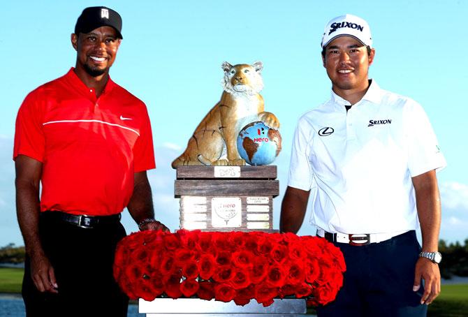Hideki Matsuyama (R) of Japan poses with the trophy and host Tiger Woods after winning the Hero World Challenge at Albany. Pic/AFP