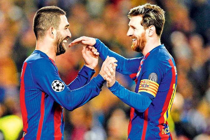 Arda Turan (left) celebrates his hat-trick with Barcelona teammate Lionel Messi during their Champions League tie against Borussia Moenchengladbach last night. Pic/AFP