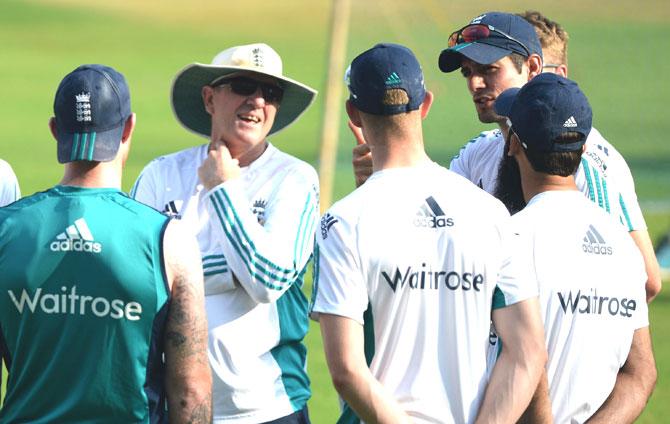 England coach Trevor Bayliss (2L) listens as captain Alastair Cook (2R) speaks during a training session at the Wankhede stadium ahead of the fourth test cricket match between India and England in Mumbai. Pic/AFP