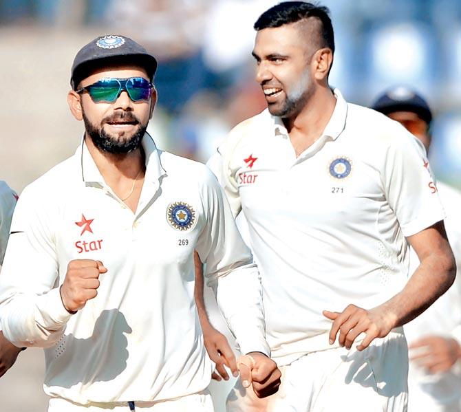 India captain Virat Kohli (left) and R Ashwin celebrate the wicket of England