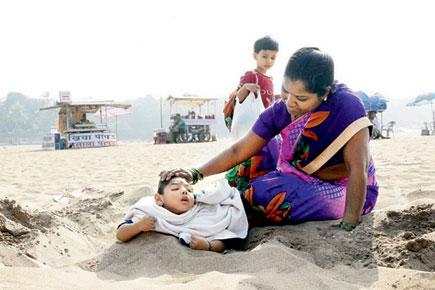 Mum digs pit on Mumbai beach for physically challenged baby's therapy