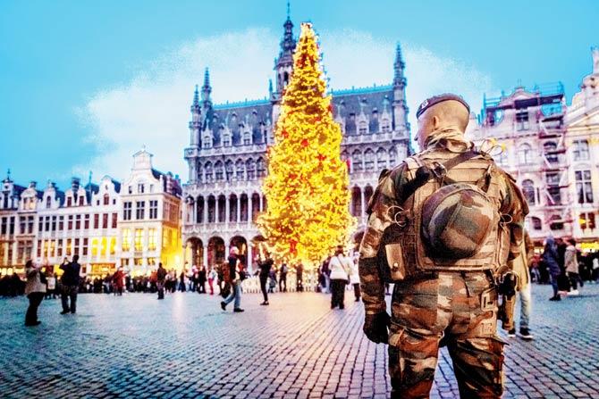 A serviceman patrols the Groote Markt on the sidelines of ‘winter wonders’ Christmas market, in Brussels. Pic/AFP