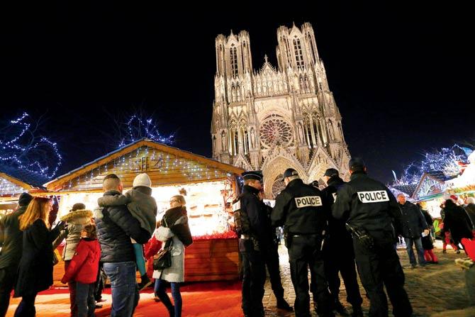 Police officers patrol at the Christmas market next to the Cathedral of Notre-Dame de Reims, in Reims. Pic/AFP