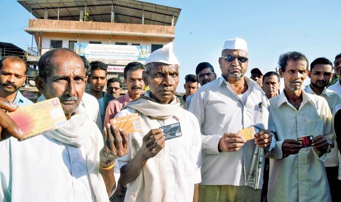 Dhasai villagers lineup with their cards for the cashless transactions