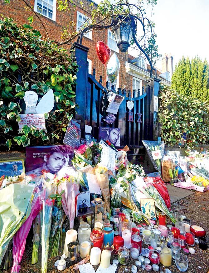 Flowers, candles and messages left by well-wishers and fans in tribute outside the north London home of singer George Michael. Pic/AFP