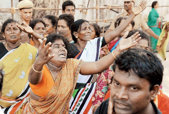 Mourners wait for a glimpse of Jayalalithaa during her funeral. Pics/PTI, AFP