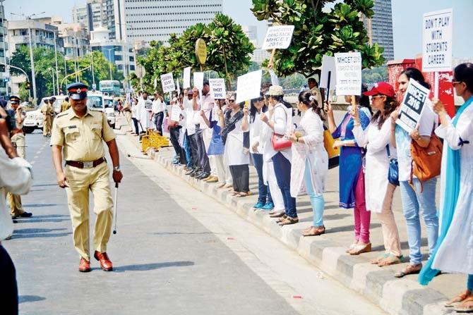 Students and parents form a human chain at Marine Drive in May to protest against the implementation of NEET for medical aspirants. File pic