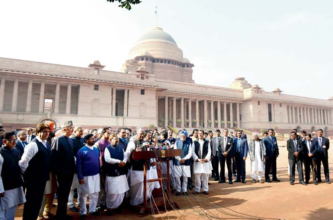 Congress party members gather outside the Presidential Palace after meeting President Pranab Mukherjee in New Delhi. Pics/AFP
