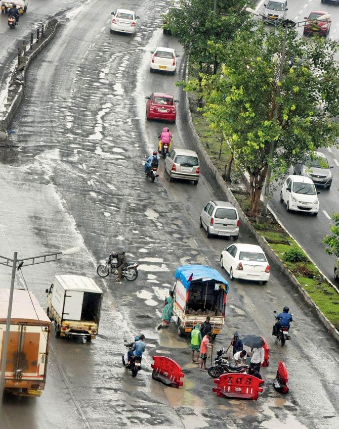 The rocky road on the Western Express Highway continues to be a treacherous navigation. File pic