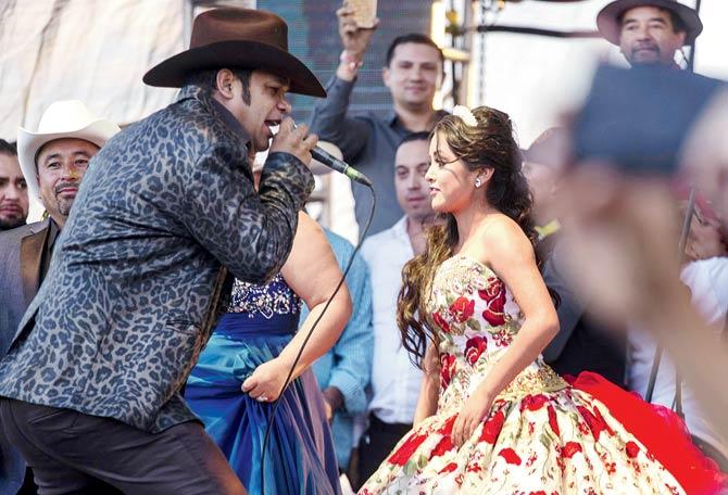 Rubi Ibarra dances with a singer during her 15th birthday celebrations in Villa de Guadalupe, San Luis Potosi State, Mexico. Pic/AFP