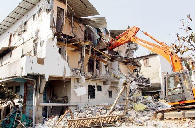 Officials of TMC demolish Satyam Lodge on the second day of the demolition drive being conducted by it