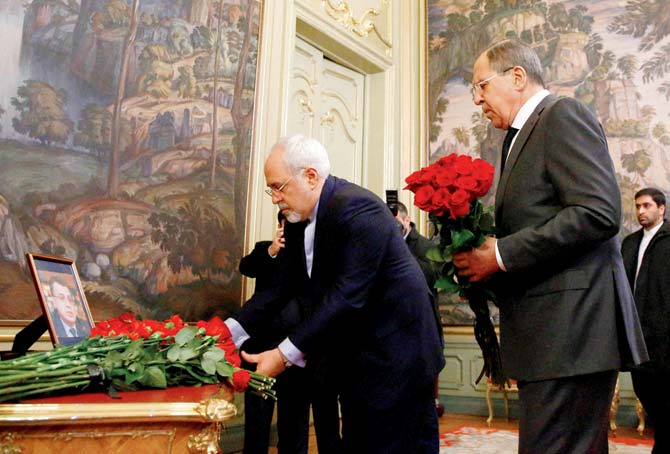Russian Foreign Minister Sergey Lavrov, second right, and his Iranian counterpart Mohammad Javad Zarif lay flowers in memory of Andrei Karlov. Pic/AP/PTI
