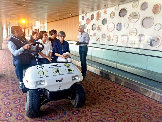 In the front row of the buggy, artists Sheetal Gattani and Meera Devidayal, whose works are part of Jaya He, the airport’s museum