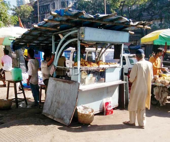 These stalls are still in operation despite a High Court order to shut them. Though the boards have been given a fresh coat of paint, the ‘Shiv Vada Pav’ is still visible underneath the whitewash (left). Pic/Nimesh Dave