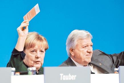 Angela  Merkel retains party leadership, proposes burqa ban