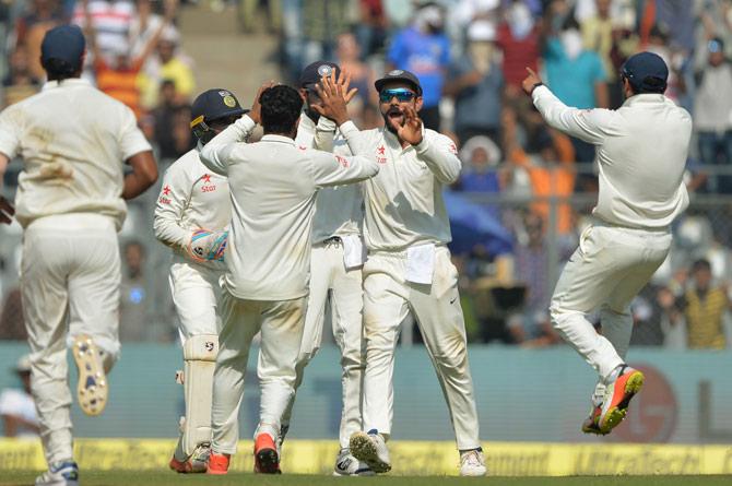 R Ashwin, Virat Kohli and Cheteshwar Pujara celebrate a wicket