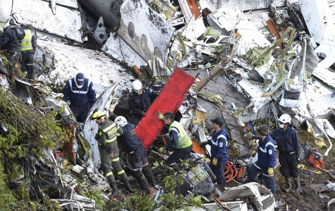 Rescue workers comb through the wreckage site of an airplane crash, in La Union, a mountainous area near Medellin, Colombia