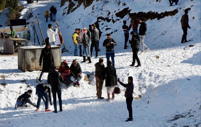 Tourists enjoy the snow at Mahashu peak in Kufri near Shimla on Monday. Pic/PTI  Children enjoying snow at Mahashu peak at Kufri, 17 Kms from Shimla on Monday. Pic/PTI