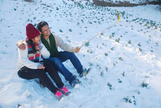 A couple taking selfie at a snow covered field at Kufri, 17 Kms from Shimla on Monday. PTI