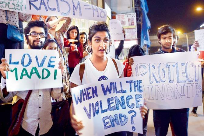 Students from colleges across Bengaluru hold placards supporting Tanzanian nationals who were assaulted last Sunday. Pic/pti