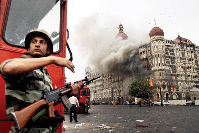 Smoke is seen billowing out of the ground and first floor of the Taj Hotel during security personnel’s ‘Operation Cyclone’ following the 26/11 terror attacks in 2008