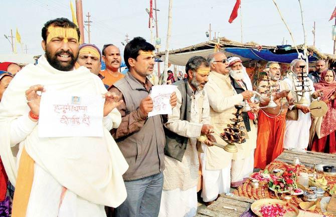 Devotees pray for the long life of Lance Naik Hanumanthappa Koppad on the banks of Ganga in Allahabad yesterday. Pics/PTI