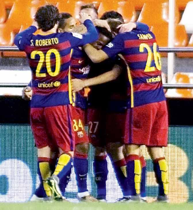 Barcelona players celebrate a goal against Valencia in Copa del Rey semis which was played in front of virtually empty stands. Pic/AFP