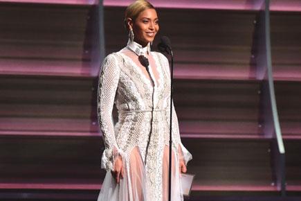 Beyonce Knowles wows in white lace gown as she takes to the stage at the Grammy Awards
