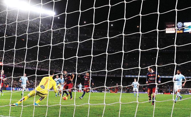 Barcelona Luis Suarez runs in to tap Messi