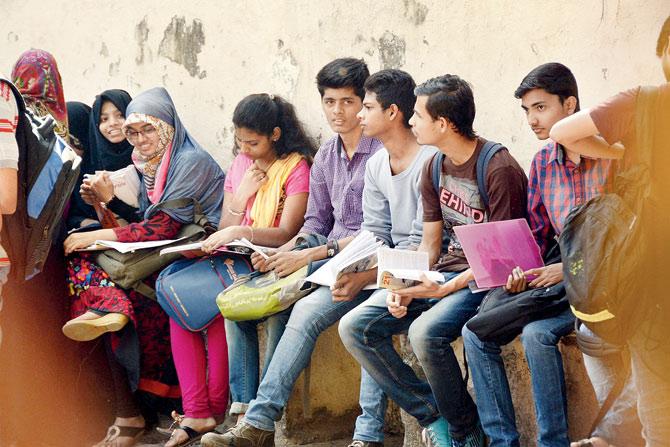 Minutes before appearing for the first HSC paper, students revise what ever they can outside an examination centre in Khar yesterday. Pic/Pradeep Dhivar 