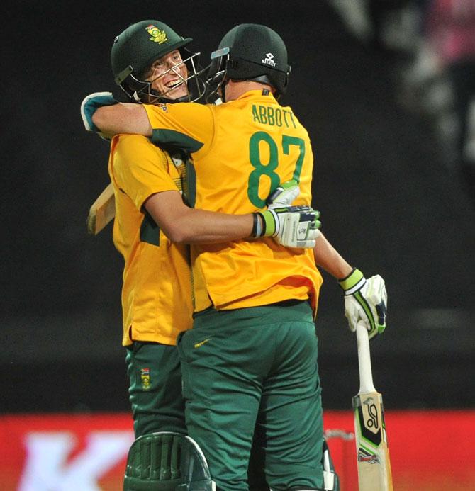 South African batsmen Chris Morris (L) and Kyle Abbott celebrate after Morris hit the winning shot during the first of two T20 matches, helping South Africa beat England by one run, at Newlands in Cape Town. Pic/AFP