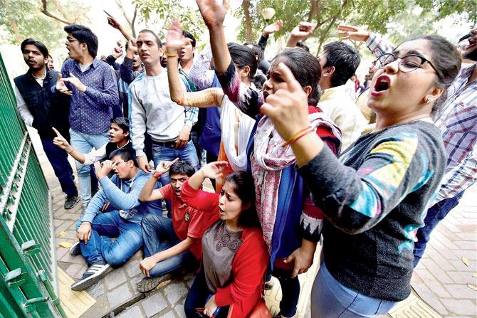 Students of ABVP shout slogans during a protest at Delhi University campus on Saturday. On its website, ABPV says: We are ‘above partisan politics’ but we accept that social activity cannot be non-political in a strict sense. However, critics says, ABVP is today, fucntioning as the students wing of the ruling Bharatiya Janata Party. PIC/PTI
