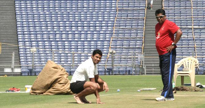 Will it stay green? Mumbai skipper Aditya Tare inspects Pune’s Maharashtra Cricket Association Stadium pitch with coach Chandrakant Pandit yesterday