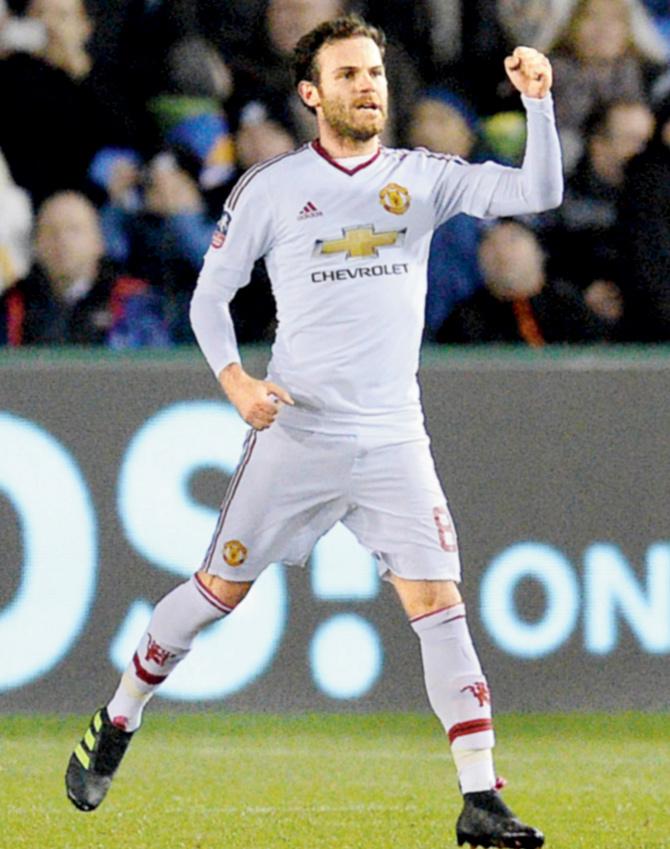 Manchester United’s midfielder Juan Mata celebrates after scoring a goal from a free-fick during their FA Cup match against Shrewsbury Town in Shrewsbury, England on Monday night. pic/AFP