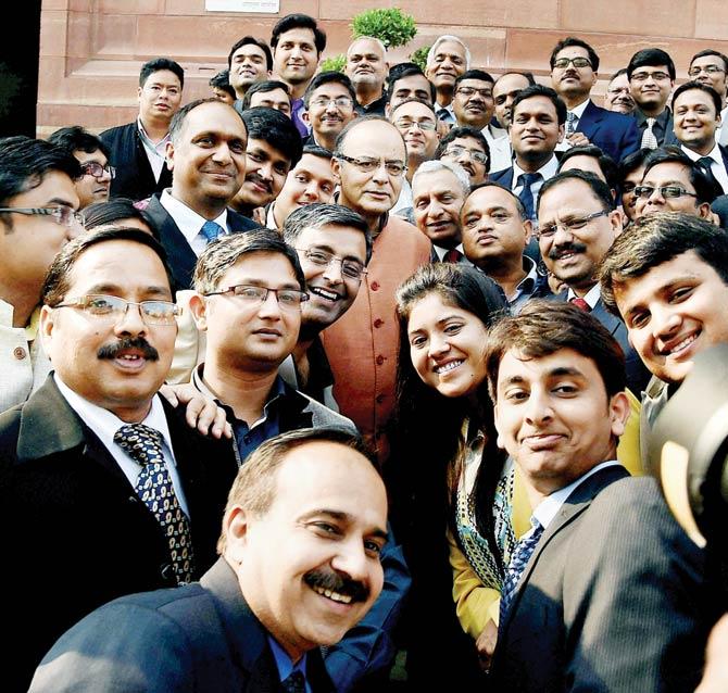 Union Finance Minister Arun Jaitley poses for a photo with Chartered Accountants visiting Parliament in New Delhi on Friday. PIC/PTI