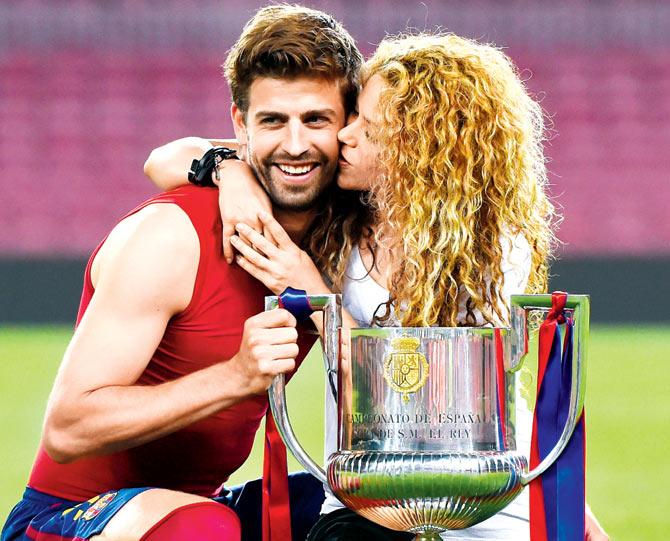Gerard Pique and Shakira pose with the trophy after FC Barcelona won the Copa del Rey final against Athletic Club in Spain at Camp Nou on May 30, 2015. Pic/Getty Images