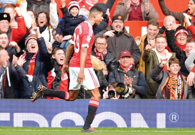 Red hot: Man United striker Marcus Rashford celebrates scoring his second goal against Arsenal in an EPL match at Old Trafford yesterday. Pic/AFP