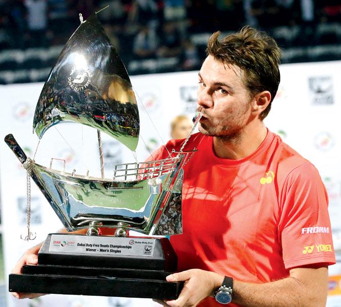 Stan Wawrinka poses with the Dubai Open trophy after defeating Marcos Baghdatis during their final match in Dubai on Saturday. Pic/AFP