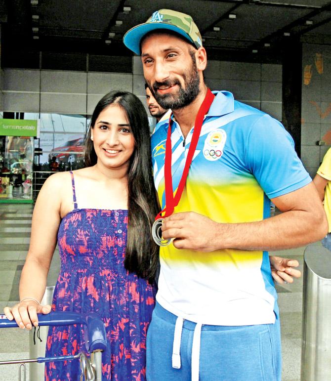 August 5, 2014: India hockey captain Sardar Singh with Ashpal Kaur Bhogal at the IGI Airport in New Delhi after returning from the 2014 Glasgow Commonwealth Games. Pic/Getty Images 