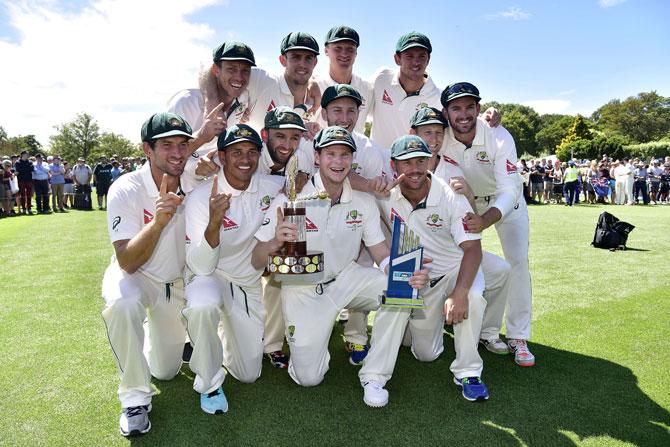 Australian captain Steve Smith holds the Trans Tasman trophy with his team after winning the 2nd Test during day five of the second cricket Test match between New Zealand and Australia at the Hagley Park in Christchurch