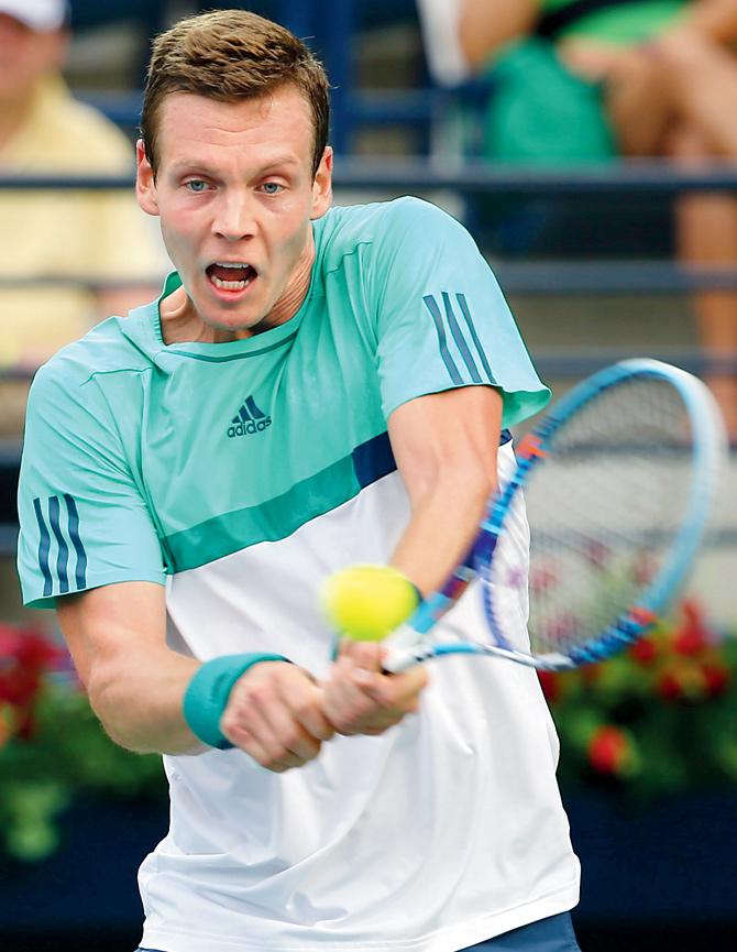 Tomas Berdych returns to Joao Sousa during their first round match of the Dubai Tennis Championships yesterday