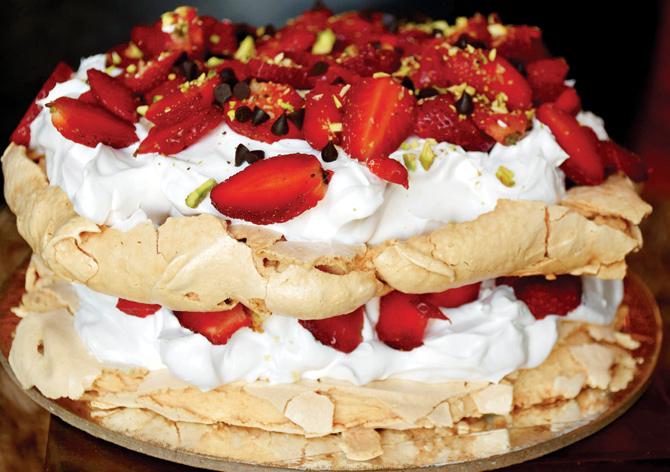 Classic pavlova cake with fresh cream and strawberries